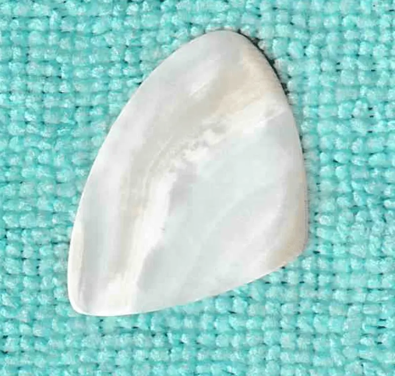 An Approximation of a 3 playing tip Scalene Shaped Pick made of Sea Shell, see my review of it. Note all the tips are fashioned differently.