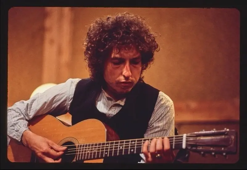Robert A Zimmerman Well known as Bob Dylan on his Martin Using an unknown pick.