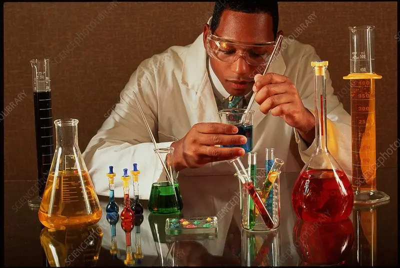 A model pretending to be a chemist (no chemist would put their face that close to a chemical, haha).