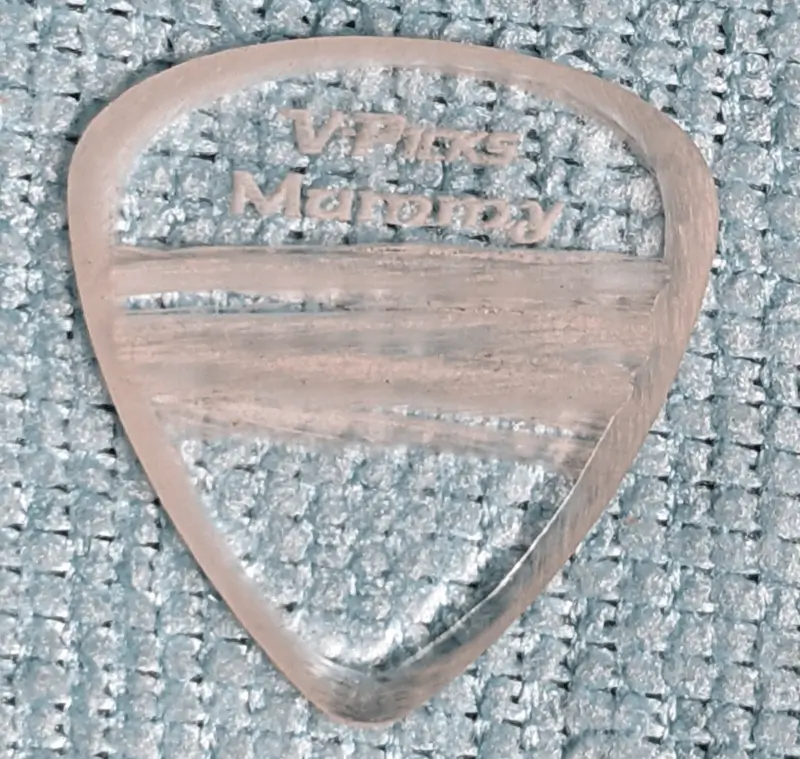 The V-Picks Brand Mummy Pick with Mummy Wrap grip strips and roughed up playing edges on blue background.