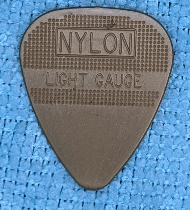 The Obverse Viewpoint of the Dunlop Herco pick 0.80mm in gold against blue background.