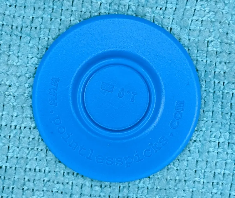 A perfectly round "Pontless" branded circule guitar pick 1.0mm in blue