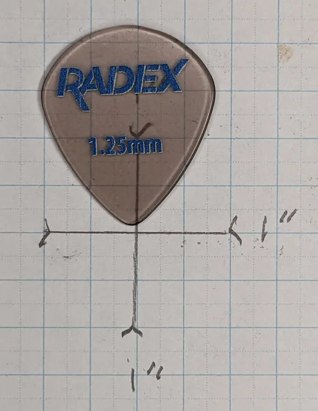 The Radex Pick by D'Andrea set against 1/4" ruled graph paper for size reference. Note the 551 based shape and size.