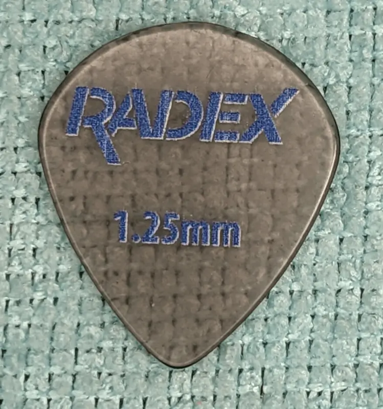 The D'Andrea Radex Brand picks of Polyphenylsulfone obverse side, note the clear nature of the material in this 551 inspired guitar pick.
