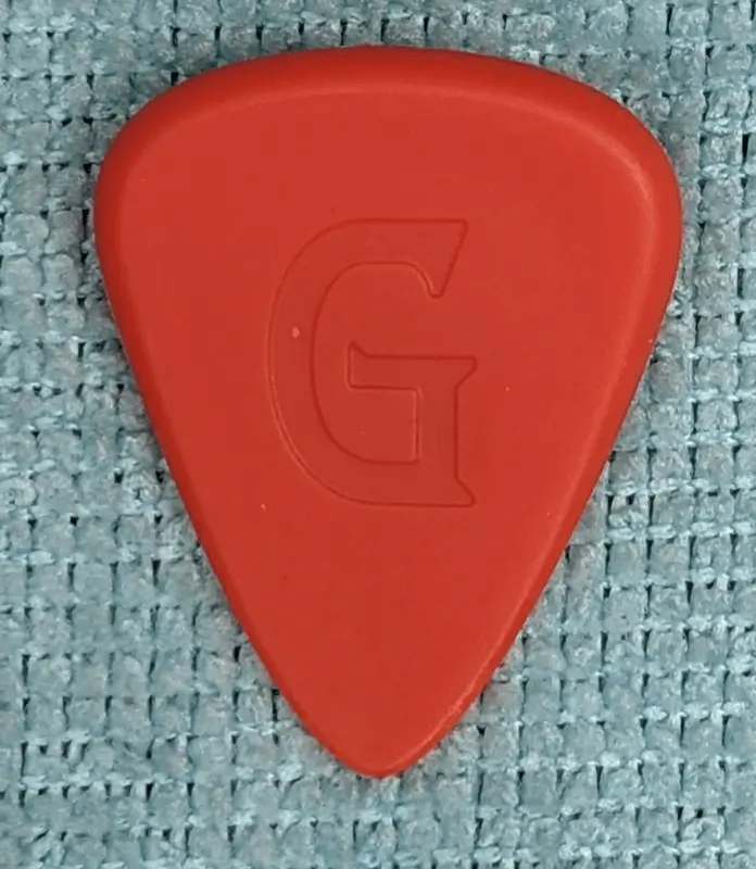 The reverse viewpoint of the Red Goonis Brand Pick. Note sculpted side for Index finger.