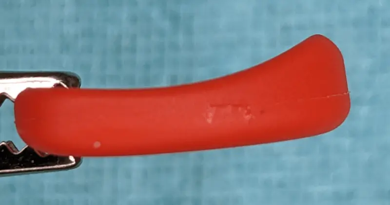 A rear side view (holding end) of the Red Goonis Pick, note extreme form fitting grip shape.