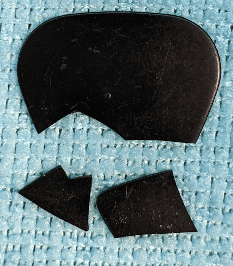 The thin ebonite Ebonay pick I broke with only moderate use Laying on Microfiber cloth.