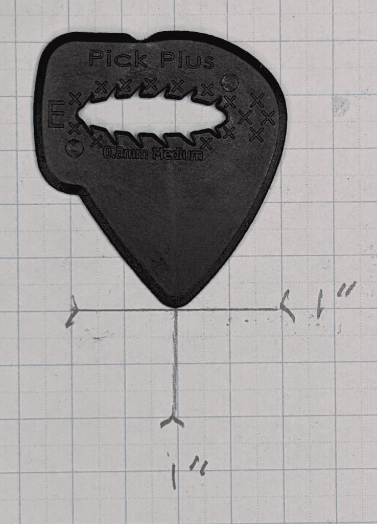 The Pick Plus .88mm Elite Model Black plectrum on graph paper which also comes in a blue 1.0mm thickness