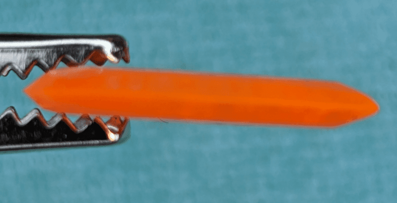 The Gravity Brand Jazz III Custom Neon Orange Pick Edge on image, note the matte finish