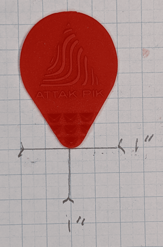 The Red Attak Pik in its teardrop shape on top of 1/4" Graph Paper for Reference