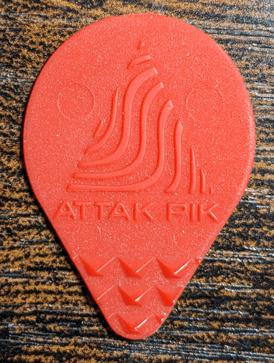 Our introduction image of the Acoustic Attak brand "attak" Pick with the playing nubs meant to multiple string strikes.