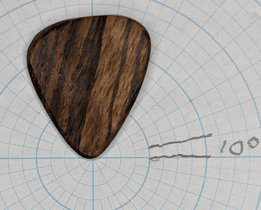 The Pickslay Zebra Wood African Pick Displayed against Angle Paper