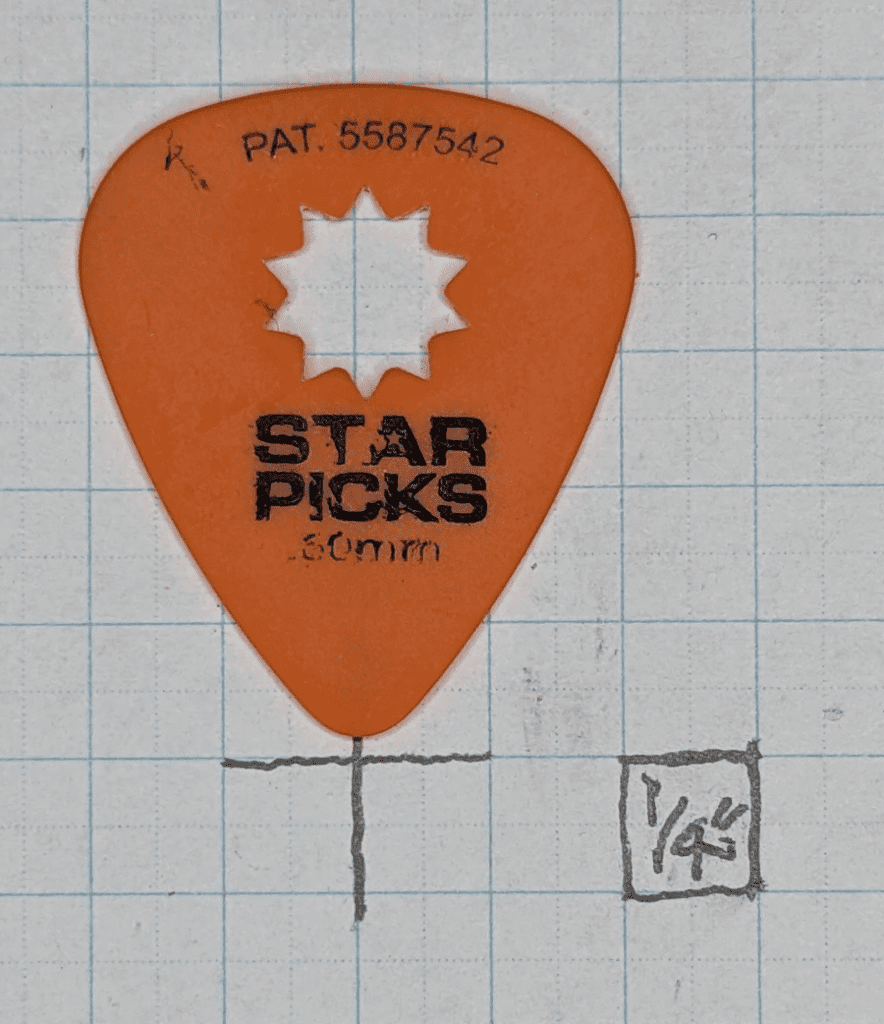 The Everly Orange Star Pick on Graph Paper Background for Reference