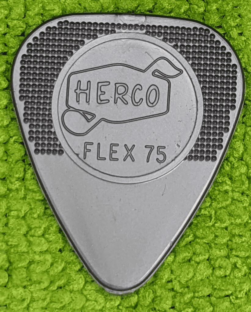 The Famous Retro-Pick, Dunlop's Herco 75 Holy Grail on Green Background.