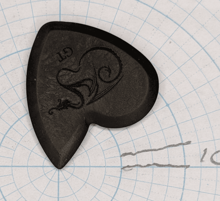 The Dragon's Heart GT Pick upside down with fine tip on Angle Paper for Shape Reference.