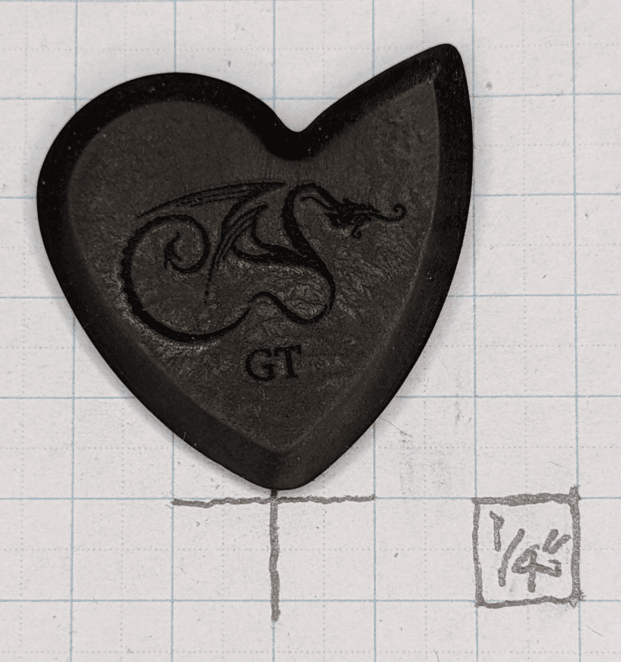 The Dragon's Heart GT Pick Set Against Graph Paper 1/4" ruled for Size Reference.