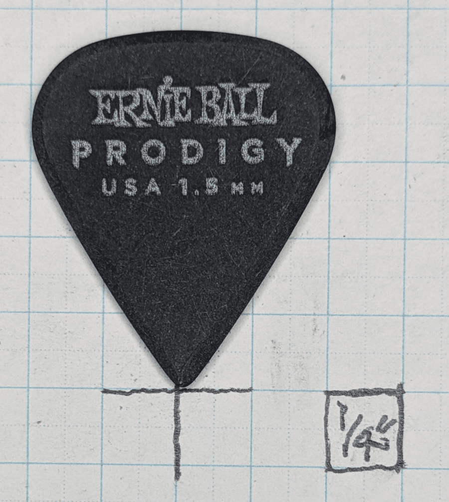 The Ernie Ball Prodigy Sharp Model 1.5 on Graph Paper. Note the Spindle Top Shaping of the plectrum with sharp shoulders.