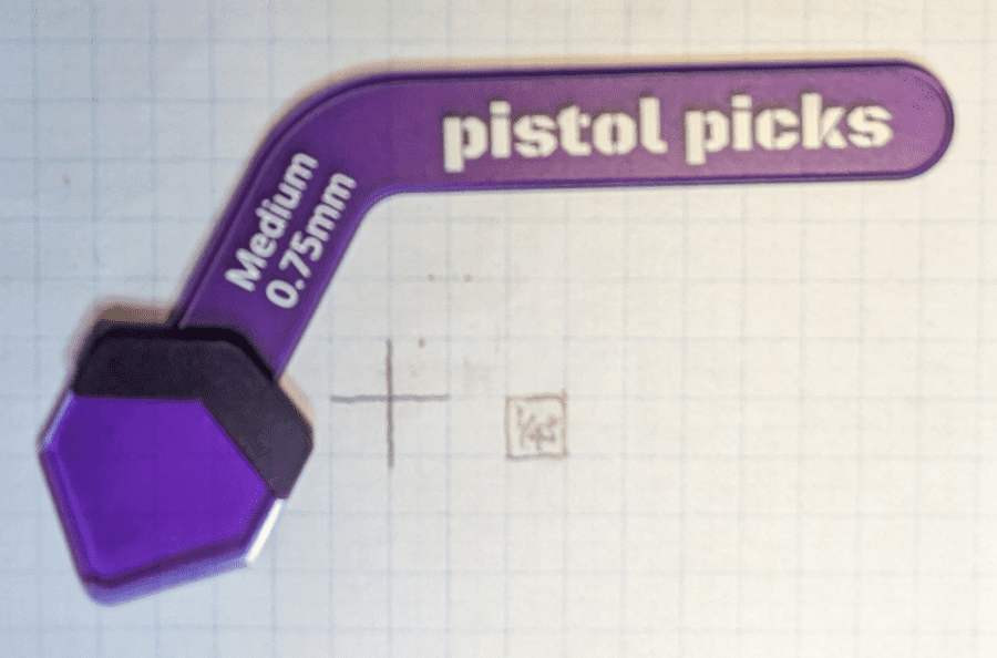 The Medium Gauge Pistal Pick. Set against 1/4" ruled paper for sizing, note how long the handle is, is it cumbersome or just right?